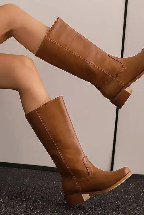 Elegant black knee-high boots with stacked heels from Lumina Wear, featuring a sleek design and smooth leather finish.
