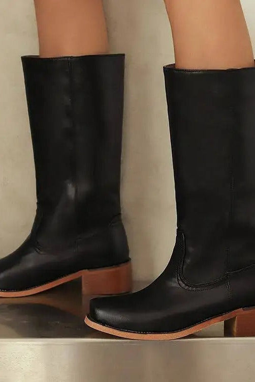 Black knee-high boots for women by Lumina Wear featuring a sleek design and stacked heel, styled with the Isabella collection.