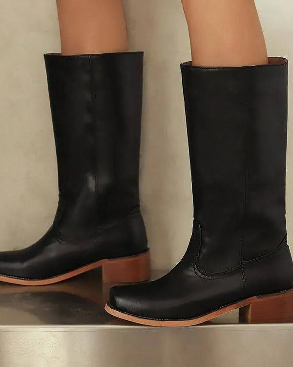 Black knee-high boots with stacked heels from Lumina Wear's Isabella collection, featuring sleek leather and elegant design.