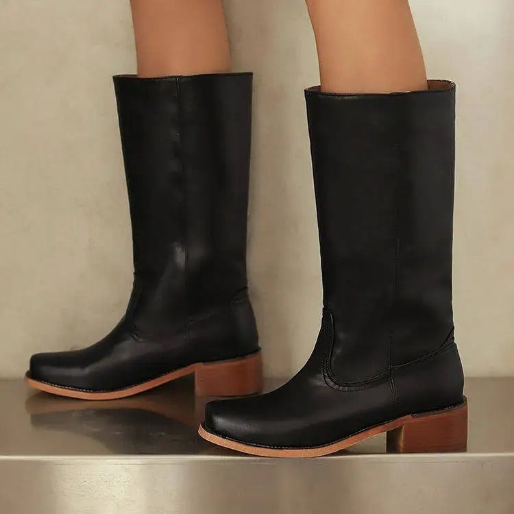 Black knee-high boots for women by Lumina Wear featuring a sleek design and stacked heel, styled with the Isabella collection.