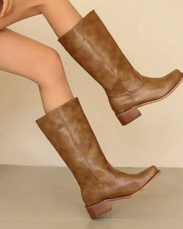 Black knee-high boots with stacked heels from Lumina Wear, featuring sleek design and elegant style.