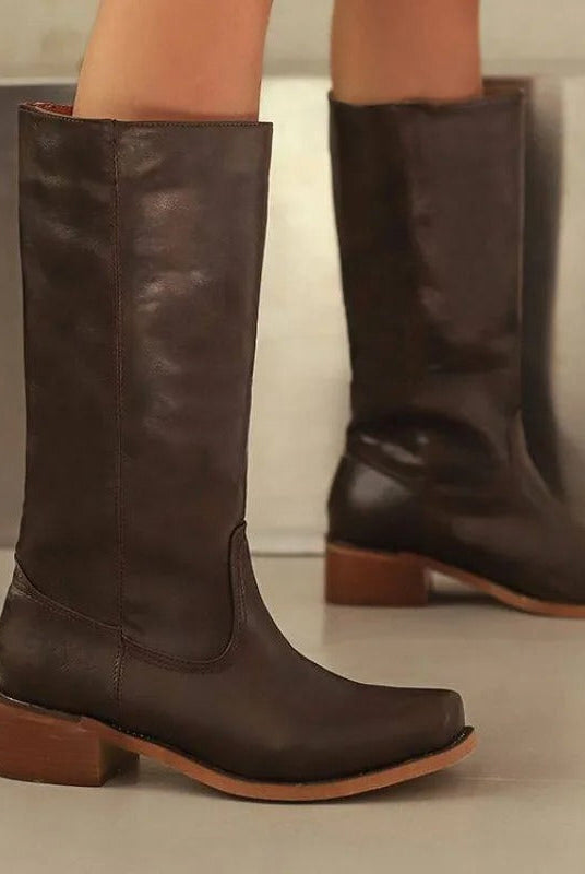 Elegant black knee-high boots by Lumina Wear featuring a stacked heel and sleek design, ideal for stylish women's footwear.
