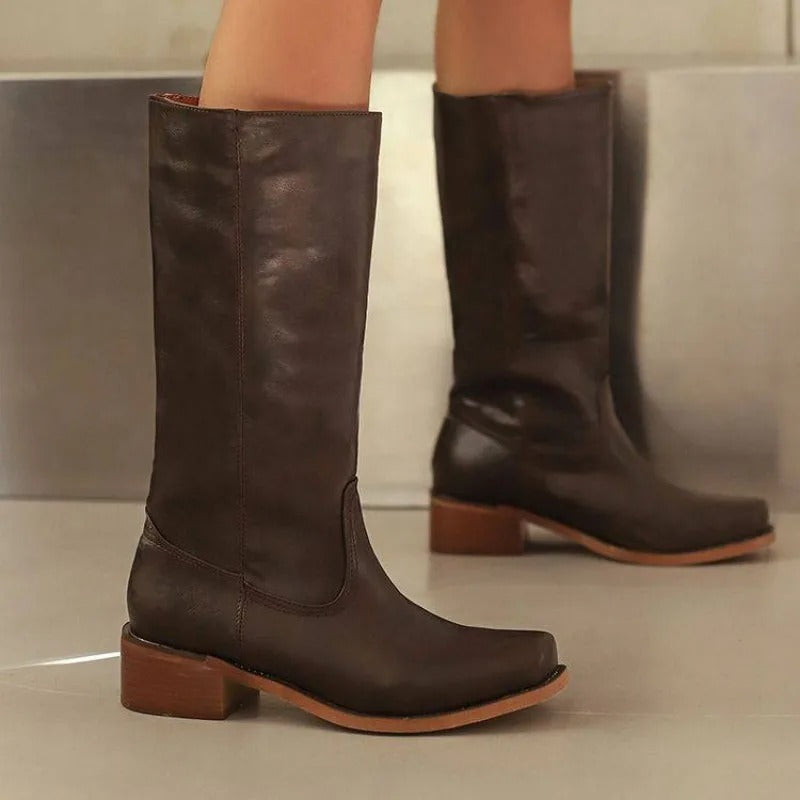 Elegant black knee-high boots by Lumina Wear featuring a stacked heel and sleek design, ideal for stylish women's footwear.