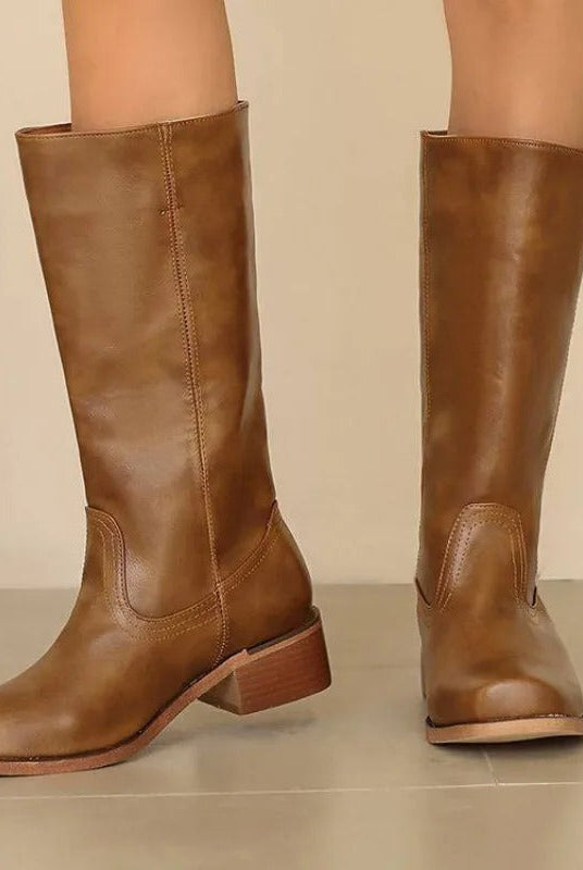 Black knee-high boots for women with stacked heels, stylish and elegant, by Lumina Wear, shown on a neutral background.