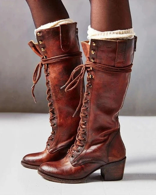 Black knee-high lace-up boots with side zipper from Lumina Wear, featuring an elegant design and stylish silhouette.