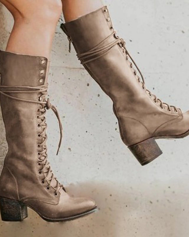 Black knee-high lace-up boots with side zipper by Lumina Wear, featuring a sleek design and elegant style.
