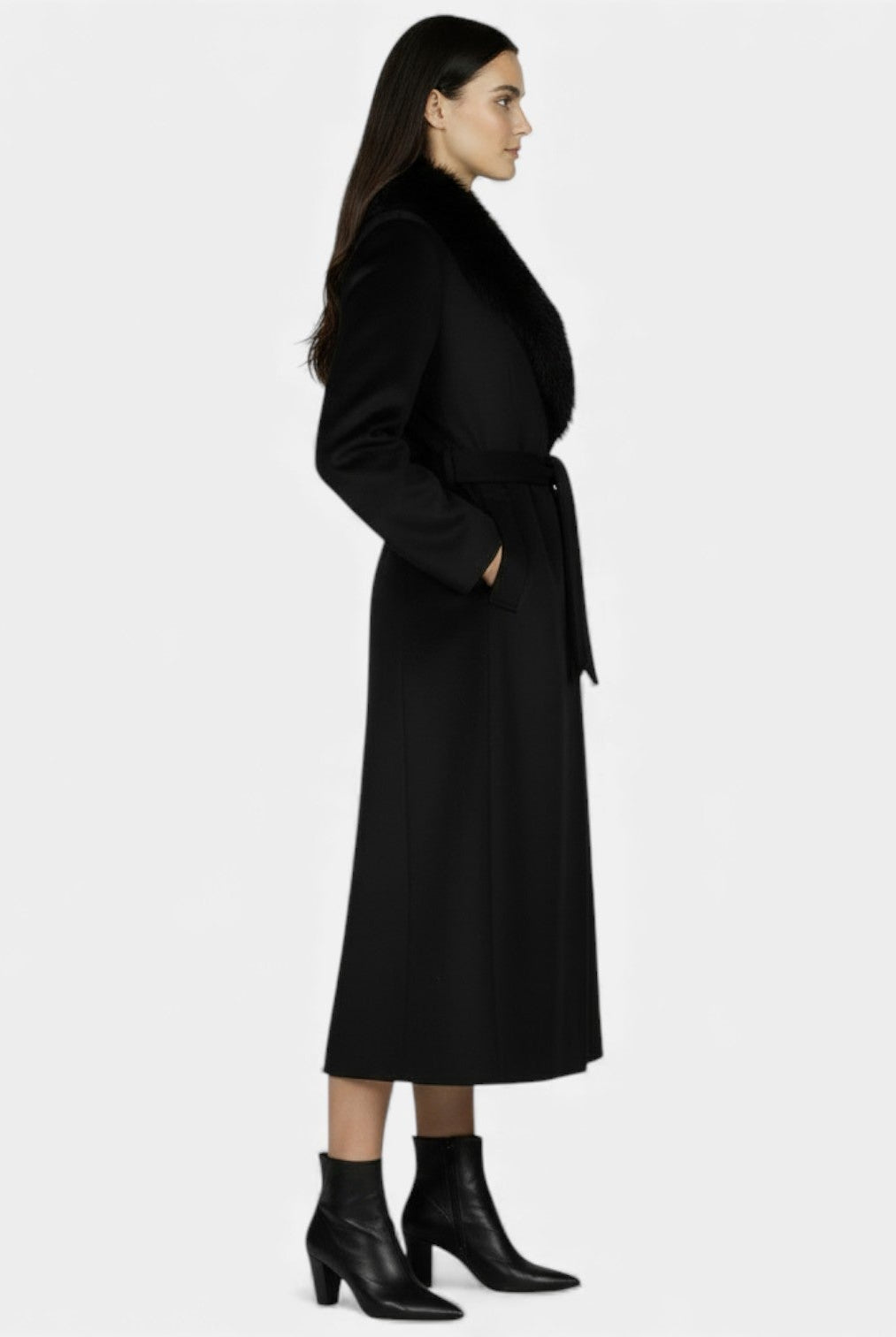 Elegant women's long wool coat with fur collar by Lumina Wear, showcased in a stylish, tailored design for winter elegance.