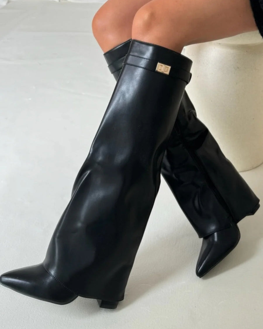 Black knee-high boots with pointed toes and side zippers from Lumina Wear's Isabella collection.