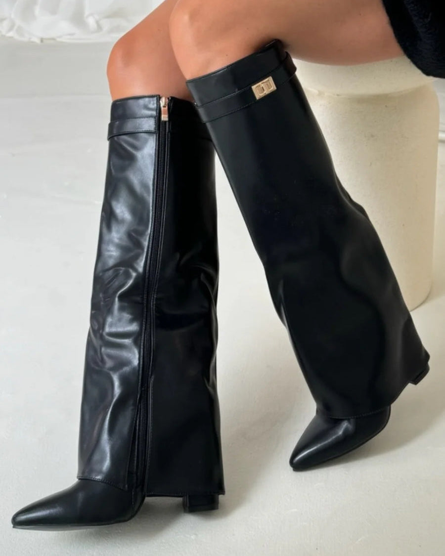 Black knee high boots with pointed toes and side zipper from Lumina Wear's Isabella collection, showcasing sleek leather design.