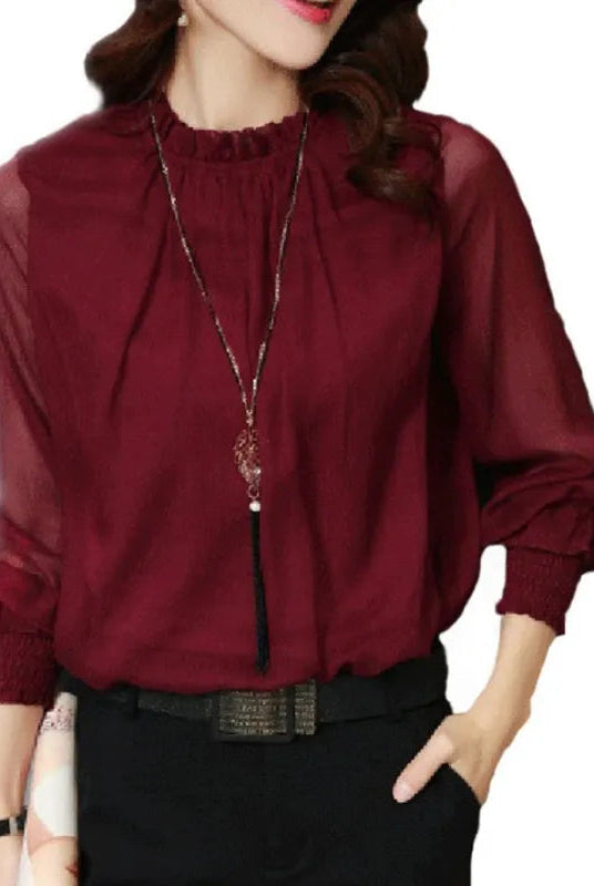 Lumina Wear Isabella elegant ruffle blouse with flowing sleeves, styled for a sophisticated look.