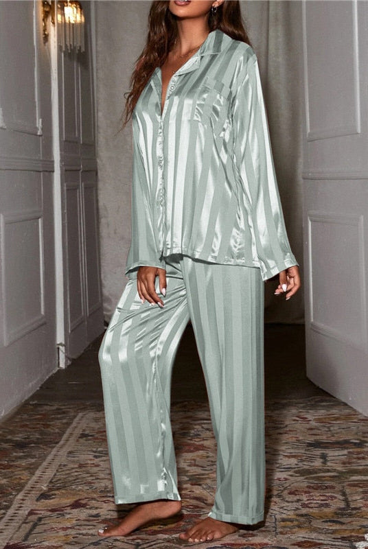 Elegant satin stripe pajama set by Lumina Wear featuring a button-front top and wide-leg pants, shown laid flat.