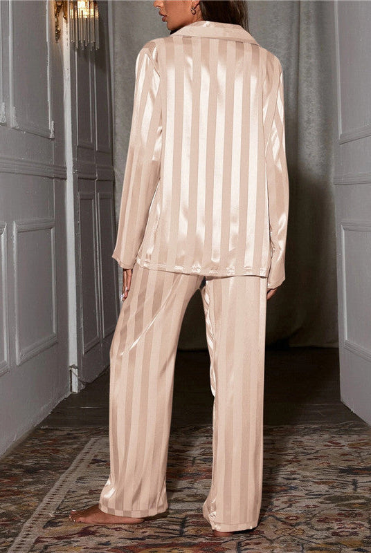 Elegant satin stripe pajama set by Lumina Wear featuring a button-front top and wide-leg pants, shown on a model.