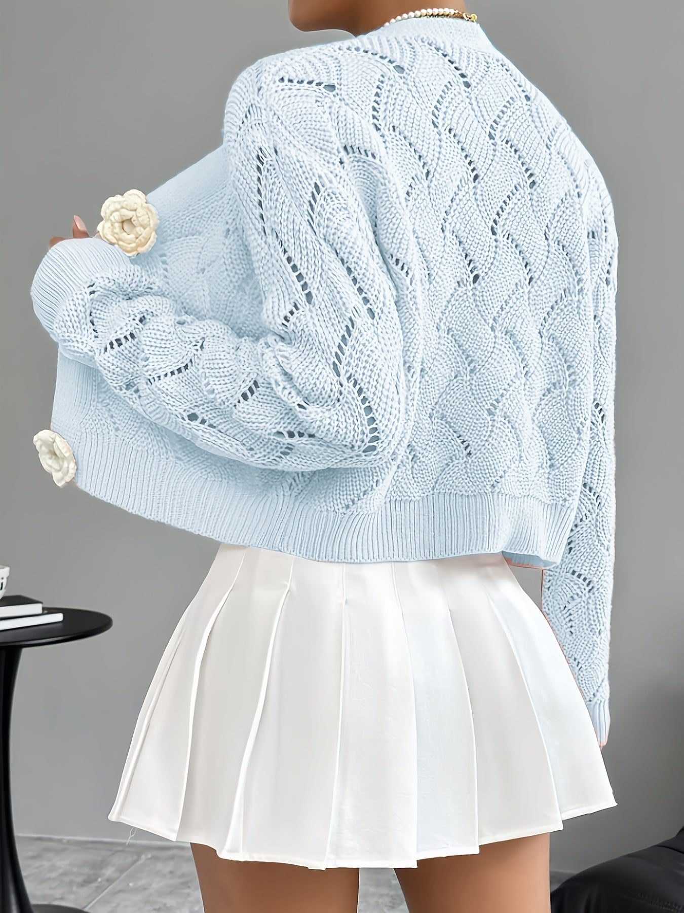 Elegant white crochet cardigan for women by Lumina Wear featuring floral button details and a stylish, delicate design.