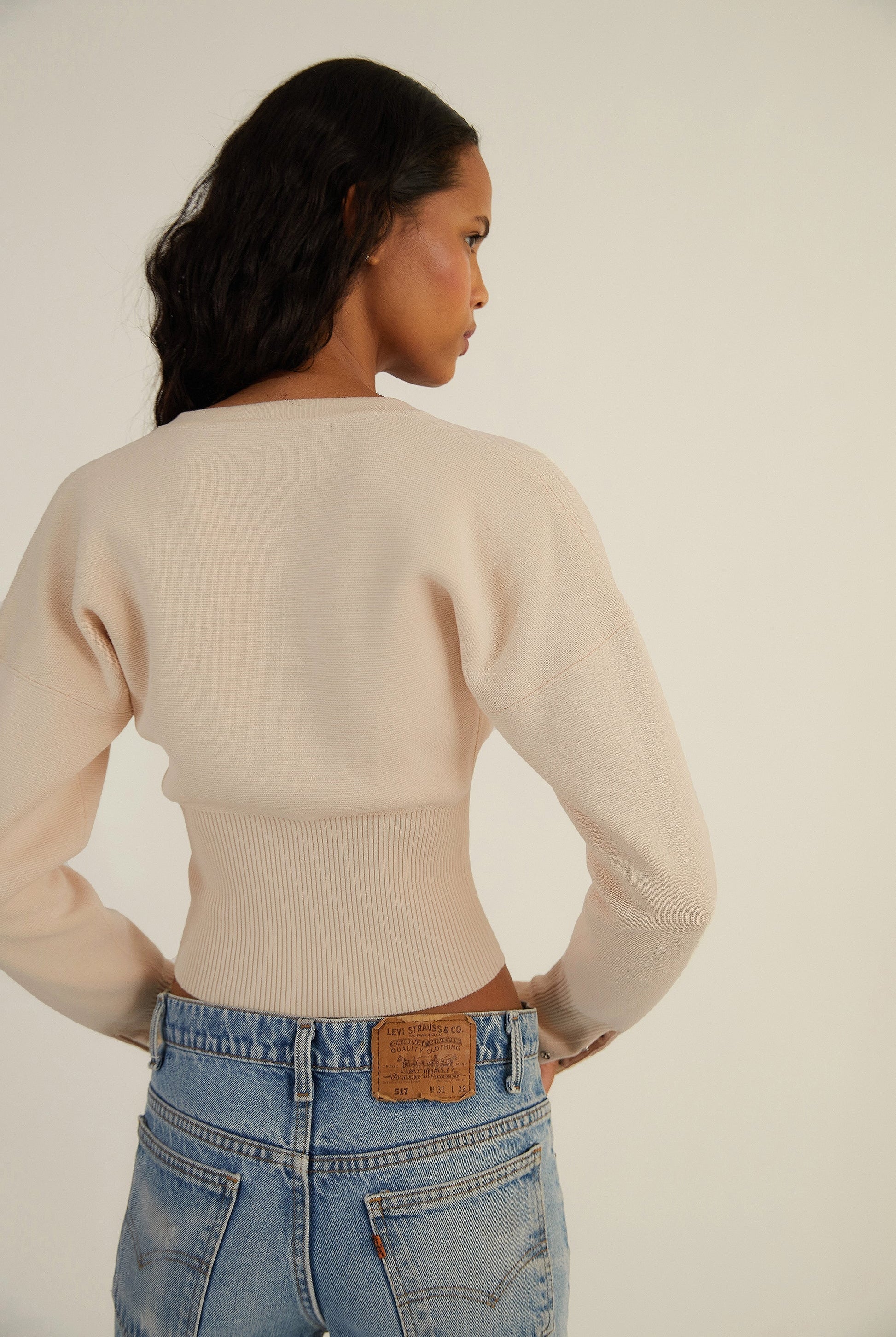 Fitted ribbed cropped cardigan with button closure from Lumina Wear's Isabella collection, showcasing a stylish and comfortable knit design.