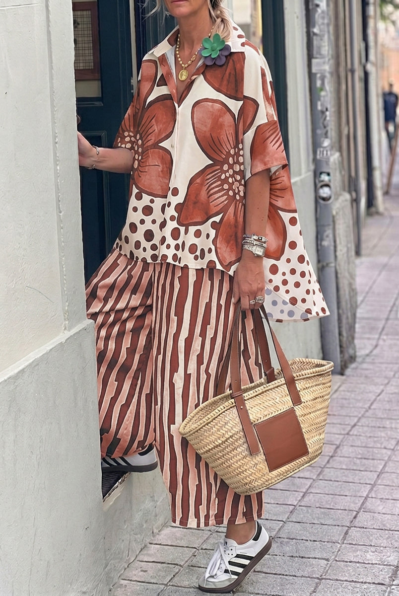 Isabella wearing Lumina Wear's floral polka-dot blouse and high-waisted trousers set, featuring a stylish, coordinated outfit.