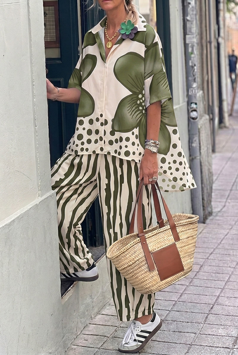 Isabella wearing Lumina Wear's floral polka-dot blouse with high-waisted trousers, showcasing a stylish set ensemble.