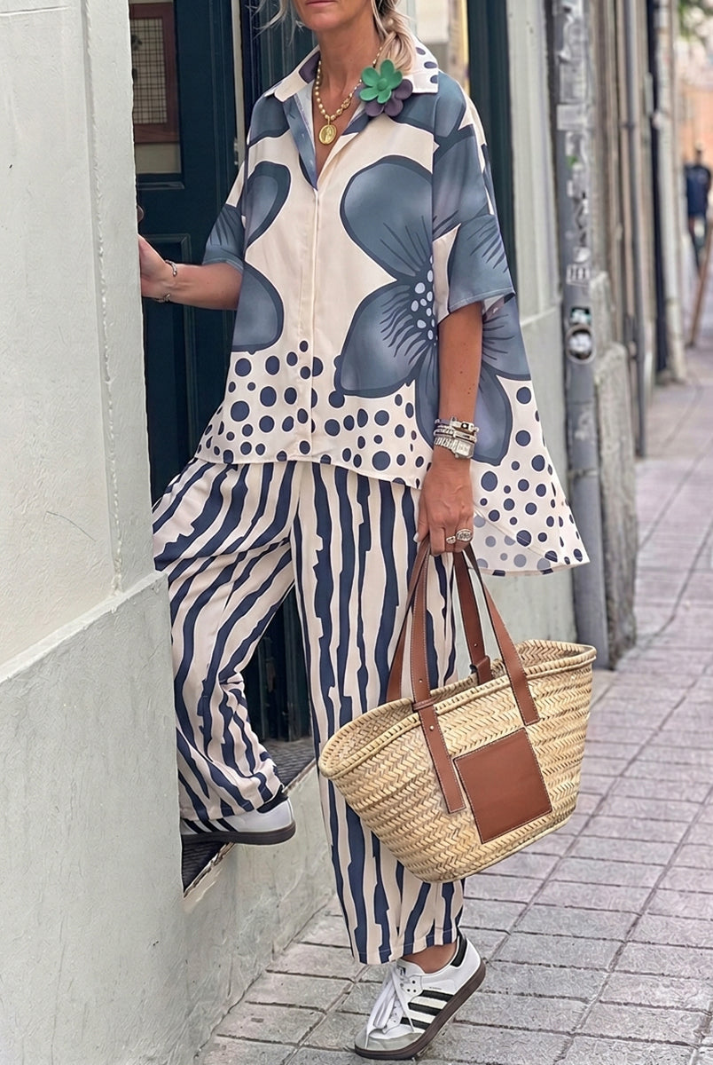 Isabella wearing Lumina Wear floral polka-dot blouse and high-waisted trousers set, featuring a stylish, feminine design.