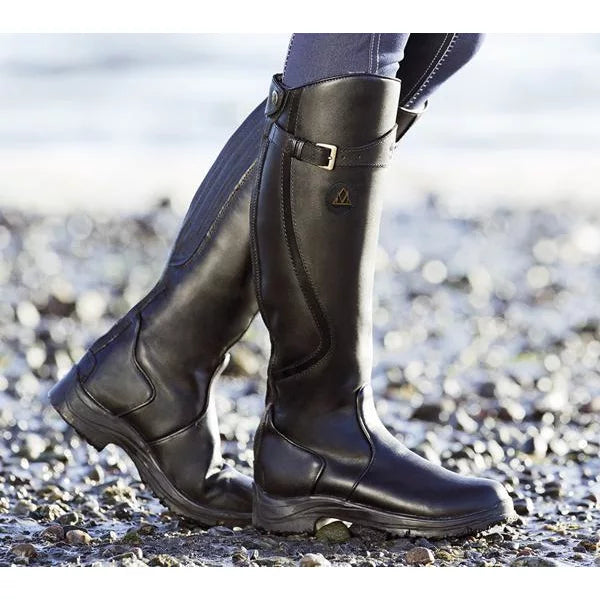 Women's knee-high buckle strap boots with ridged sole by Lumina Wear, featuring stylish straps and chunky outsole.