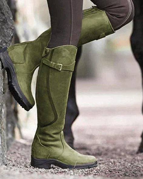 Isabella Lumina knee-high buckle strap boots with ridged sole, featuring stylish straps and chunky design, on a neutral background.