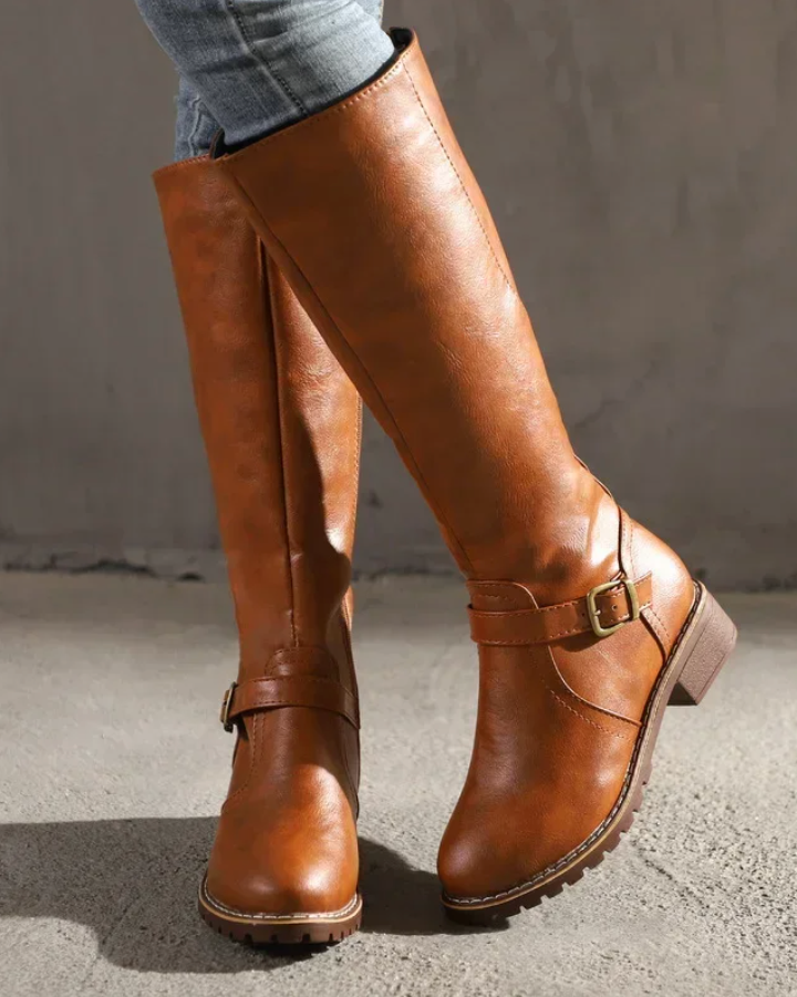 Isabella Lumina knee-high buckle strap boots with side zipper, stylish black leather footwear for women.
