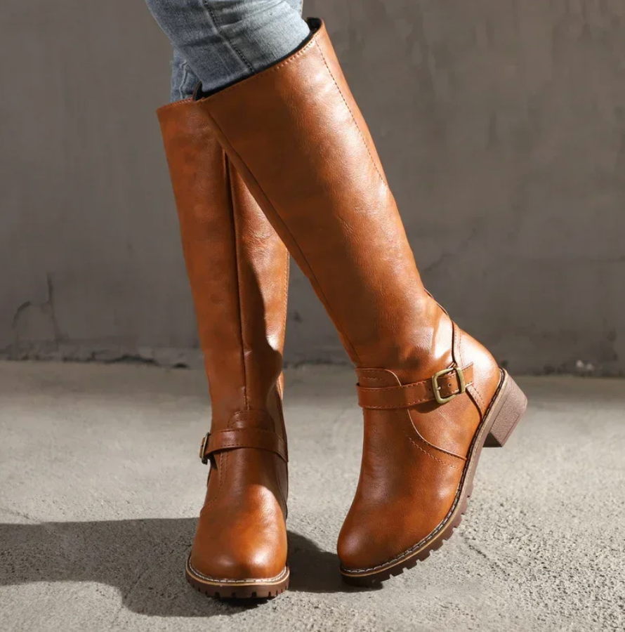 Lumina Wear Isabella women's knee-high buckle strap boots with side zipper and stylish design.