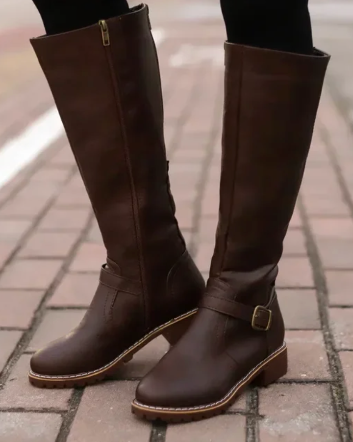 Isabella Lumina knee-high buckle strap boots with side zipper, stylish black leather footwear for women.