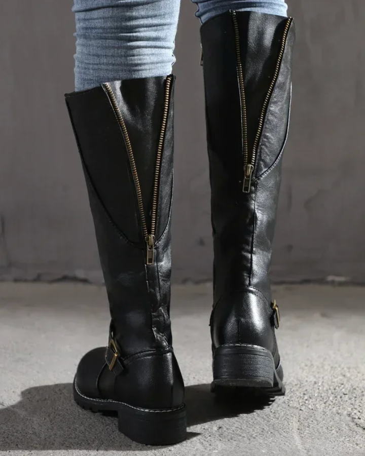 Isabella Lumina knee-high buckle strap boots with side zipper, featuring a stylish leather design and buckle accents.