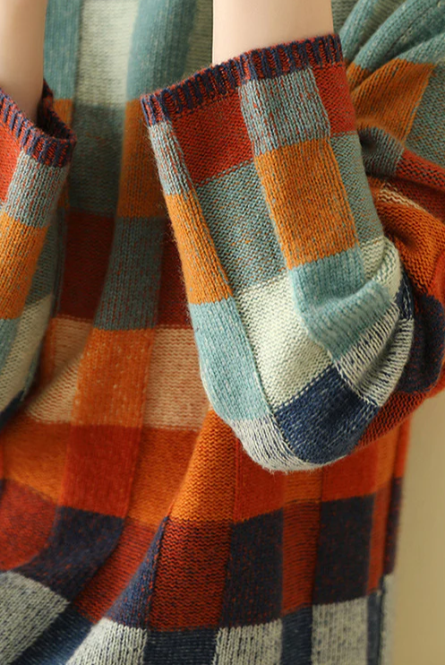 Multi-color checked sweater with mock neck from Lumina Wear, relaxed fit, cozy knit design, and vibrant pattern.
