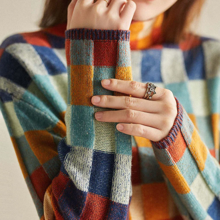 Multi-color checked relaxed fit sweater with mock neck for women, by Lumina Wear, styled on a model with long sleeves.