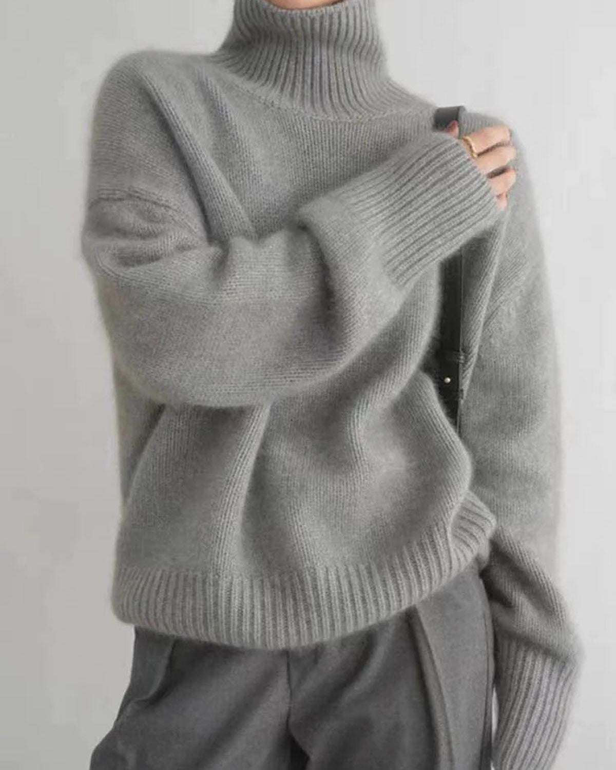 Black oversized turtleneck sweater by Lumina Wear featuring a relaxed fit and cozy knit texture.
