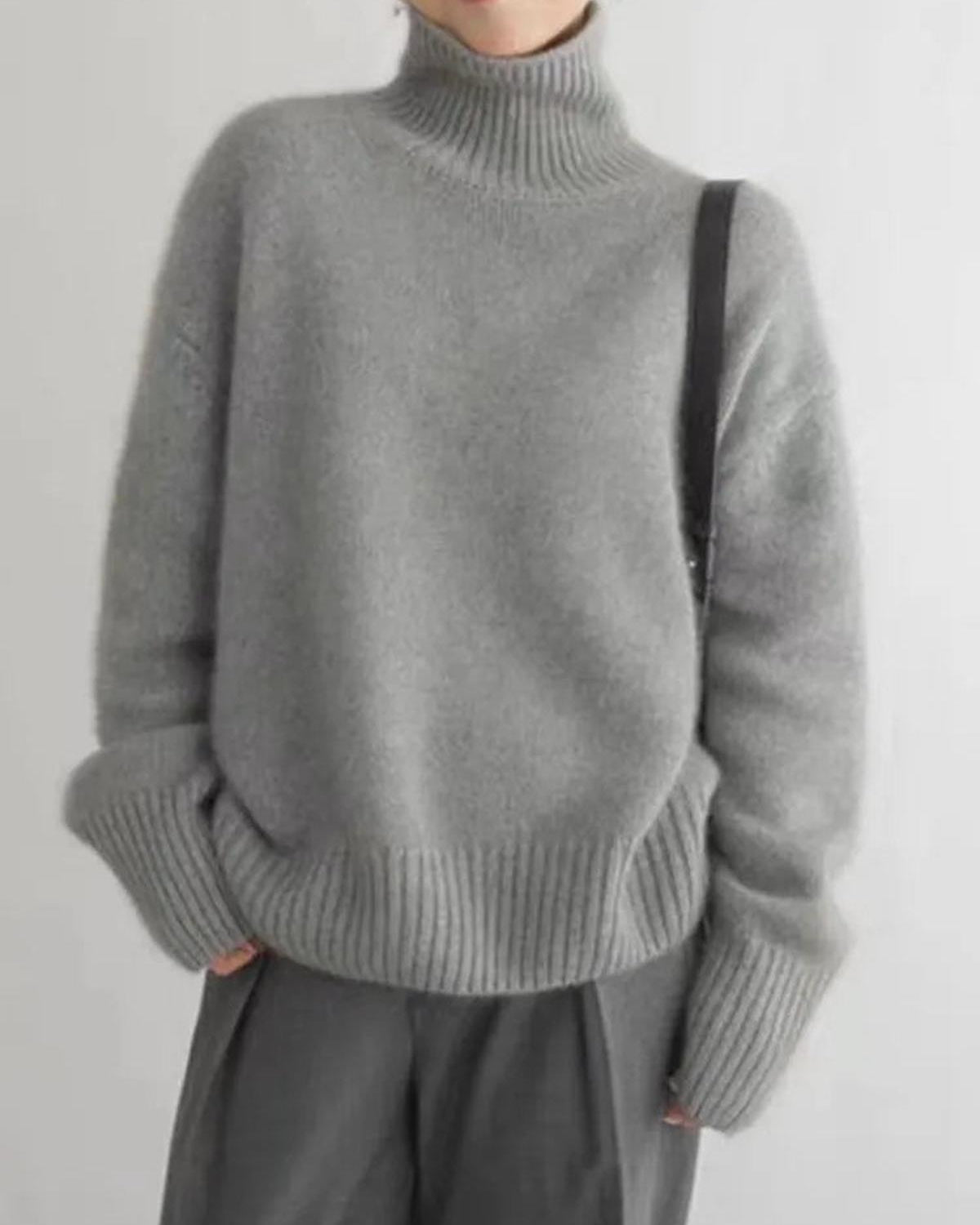 Black oversized turtleneck sweater by Lumina Wear featuring a relaxed fit, displayed on a mannequin.