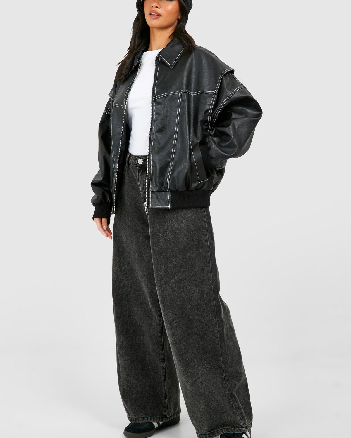 Isabella black vegan leather oversized bomber jacket with ribbed cuffs by Lumina Wear, shown on a model.