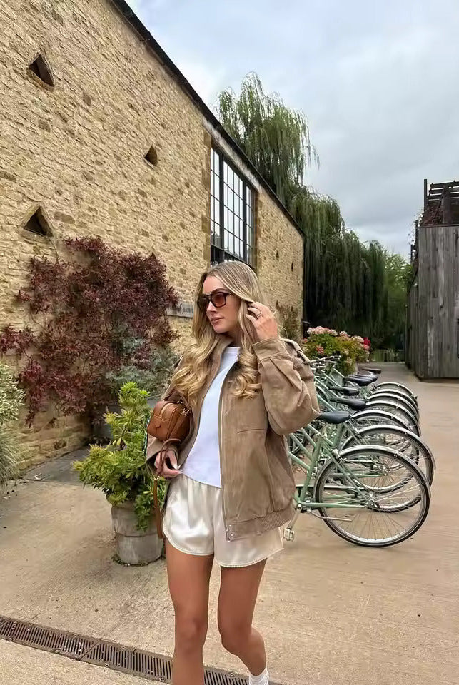 Isabella wearing the Lumina Wear Anouk oversized boxy utility jacket with stand collar, shown in a casual outdoor setting.