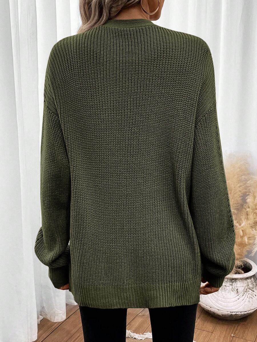 Black pointelle knit women's cardigan sweater with side split hem from Lumina Wear, featuring a relaxed fit and cozy style.