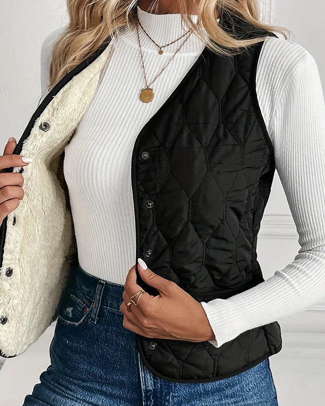 Lumina Wear Isabella quilted snap-front vest with sherpa lining, showing the padded exterior and cozy interior detail.