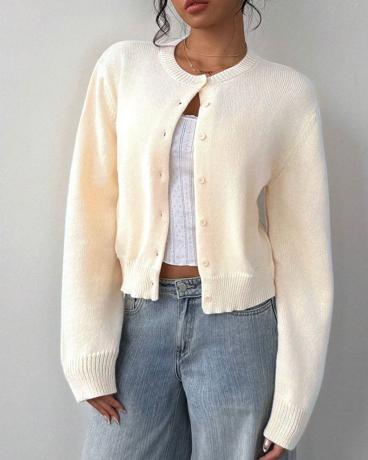 White Isabella Lumina relaxed cropped cardigan sweater with ribbed trim, shown on a model with buttons and long sleeves.