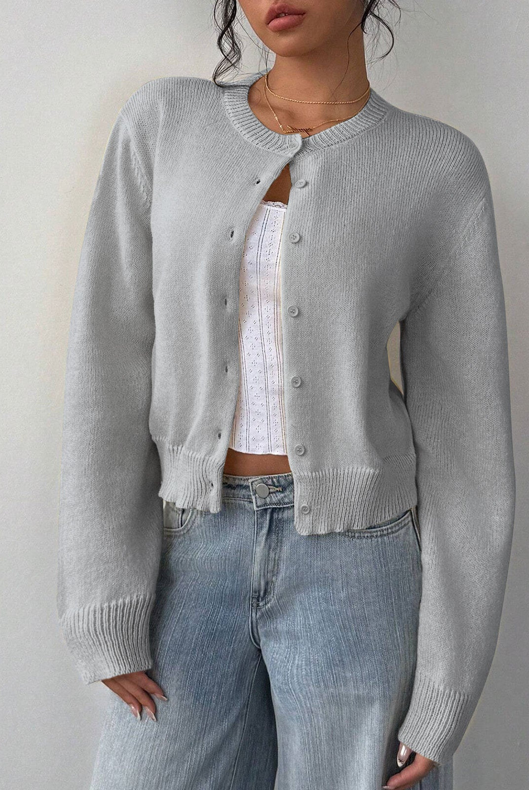 Relaxed cropped white cardigan sweater with ribbed trim from Lumina Wear, featuring a casual fit and soft knit texture.