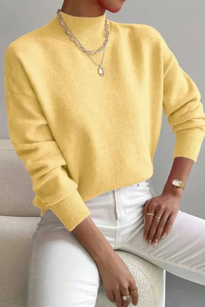 Light gray Lumina Wear Isabella relaxed fit knit sweater with mock turtleneck, soft textured fabric, styled on a model.