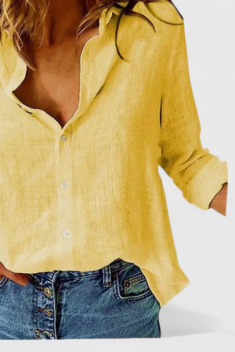 Isabella Lumina relaxed V-neck blouse with button front, lightweight fabric, in soft neutral color, displayed on a hanger.
