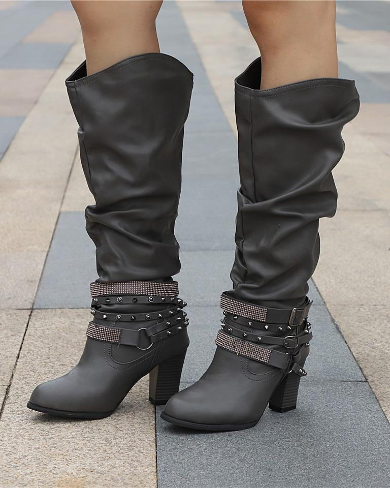 Lumina Wear Isabella knee-high boots with studded straps, slouch design, and block heel, showcasing their stylish leather finish.