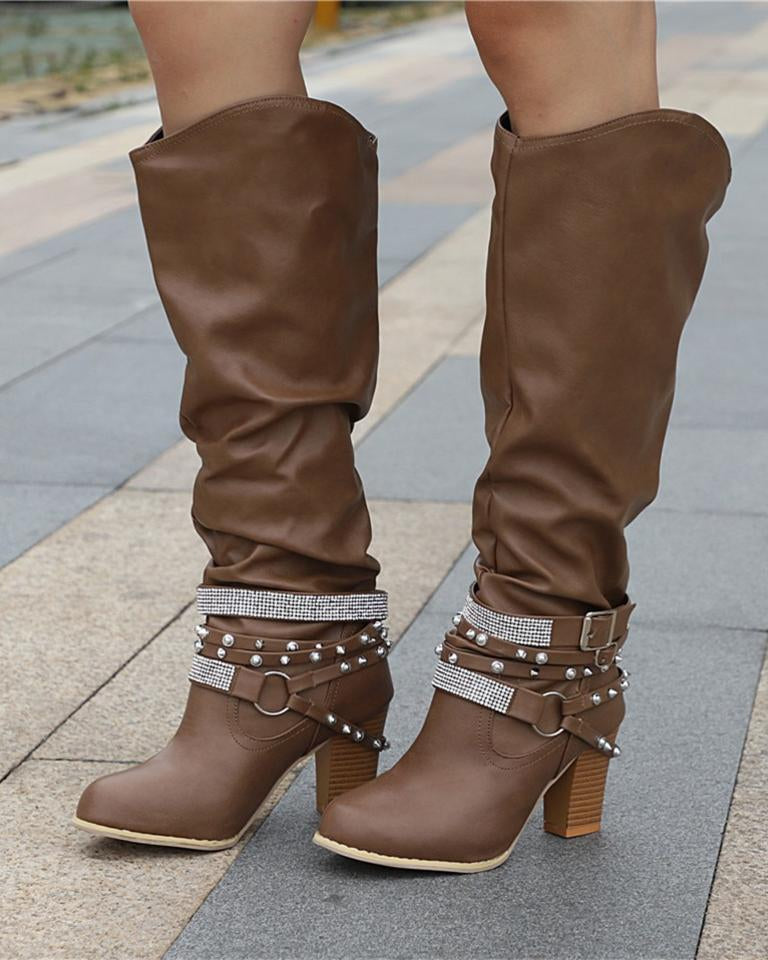 Lumina Wear Isabella knee-high boots with studded strap, slouch design, and block heel, showcasing stylish footwear detail.