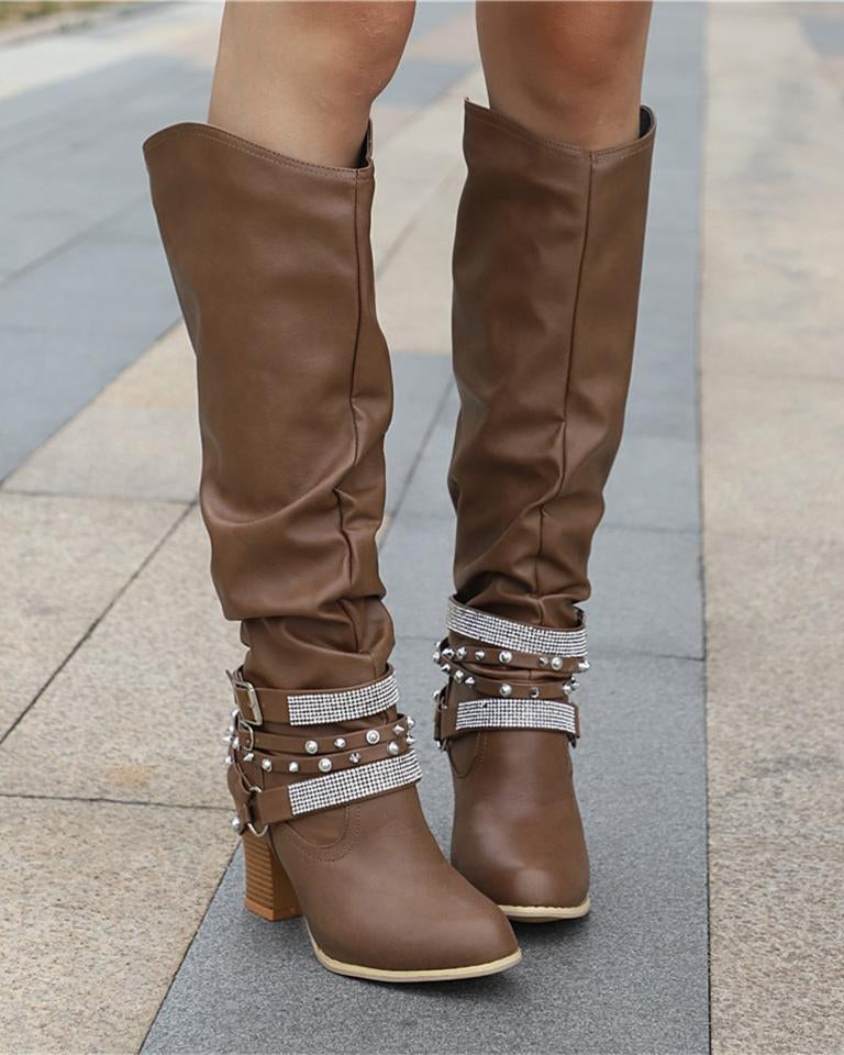 Lumina Wear Isabella knee-high boots with studded straps, slouch design, and block heel, showcasing stylish footwear details.