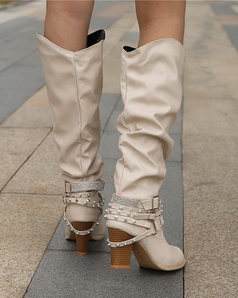 Lumina Wear Isabella knee-high boots with studded straps, slouch design, and block heel, showcasing stylish footwear detail.