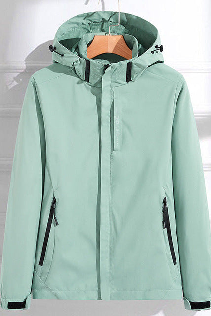 Light gray waterproof hooded women's windbreaker by Lumina Wear with adjustable fit, featuring a stylish design and wind-resistant material.