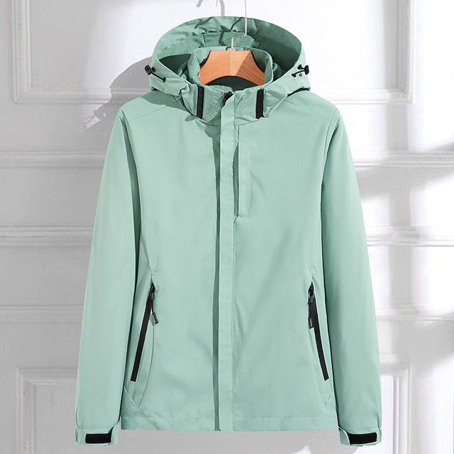 Light gray waterproof hooded women's windbreaker by Lumina Wear with adjustable fit, featuring a stylish design and wind-resistant material.