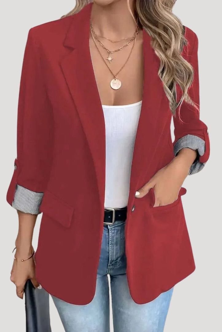 Lumina Wear Isabella tailored blazer with roll-up sleeves and flap pockets, shown on a model in a professional setting.