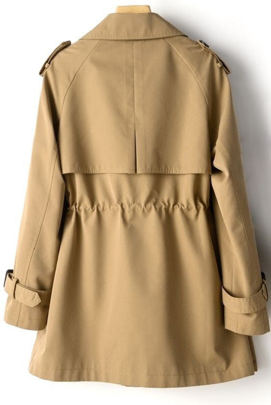 Lightweight tailored trench coat with waist cinch from Lumina Wear, beige color, featuring classic collar and belt detail.