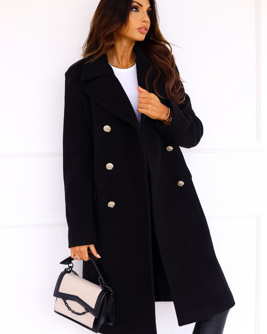 Isabella Lumina Wear tailored longline winter trench coat with structured shoulders, shown in a stylish outdoor setting.
