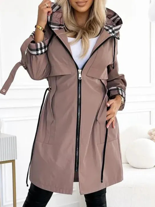 Women's waterproof Isabella parka with checked lining and drawstring waist by Lumina Wear, tailored outerwear for rainy days.
