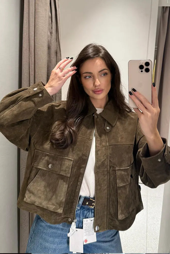 Delphine textured utility jacket by Lumina Wear featuring snap-button details and a turn-down collar, shown in a close-up view.